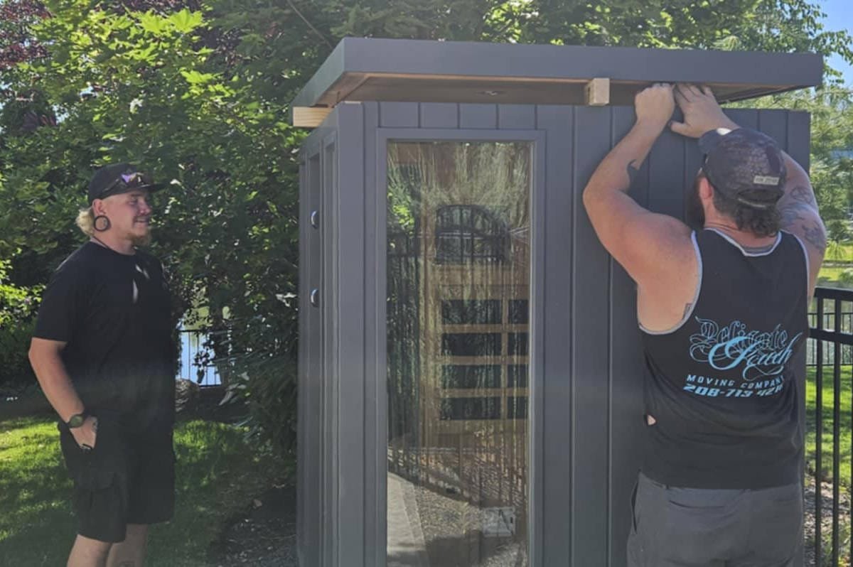Crew disassembling a sauna before transportation